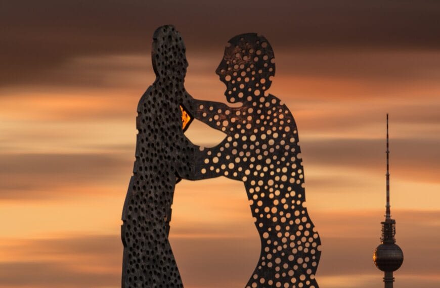 silhouette of two standing men statue during golden hour