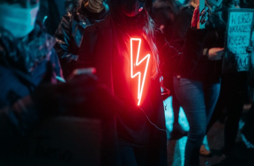 woman in red and white star print hoodie standing on stage