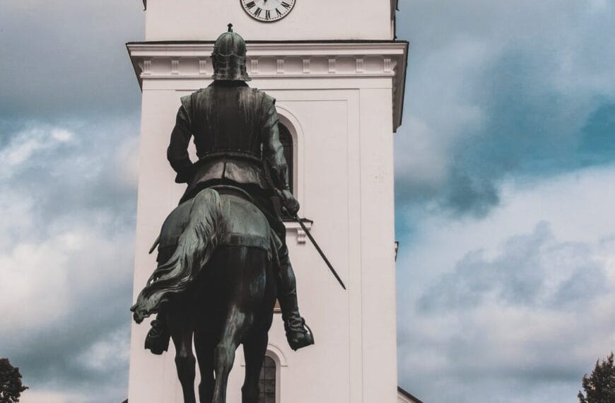man riding horse statue under cloudy sky during daytime