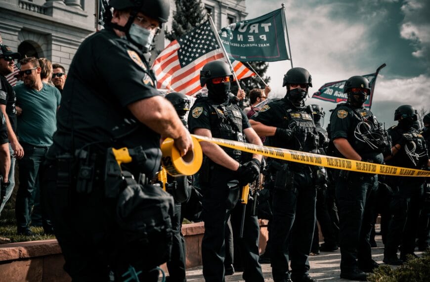 man in black shirt holding american flag