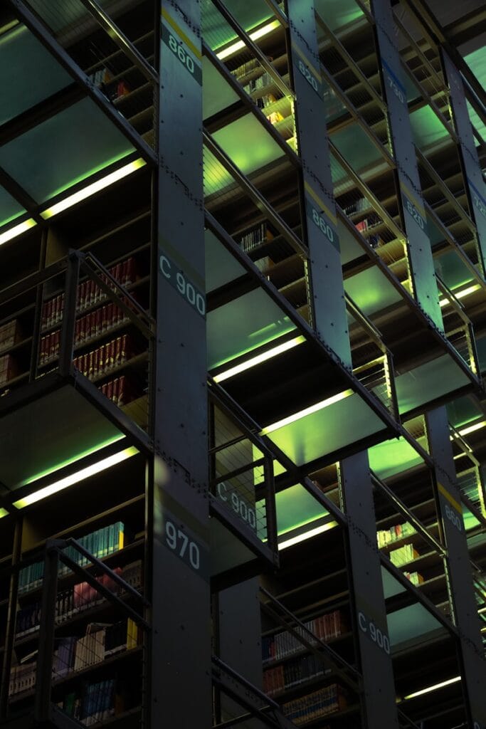 A modern library features bookshelves.